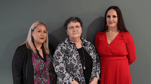 Kimberley Do, Lisa Thorpe and Stacey Brown stand side by side in front of a grey wall.