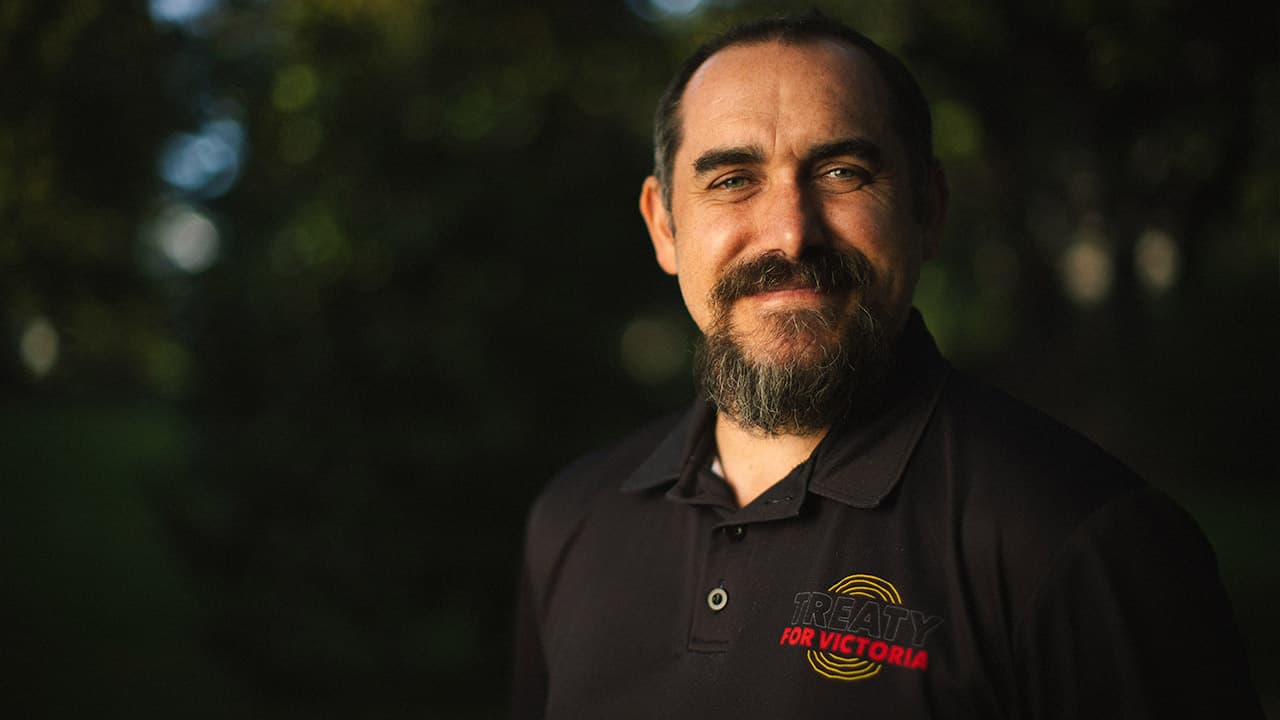 Headshot of proud Gunditjmara man Reuben Breg in a First Peoples Assembly of Victoria t-shirt.
