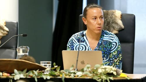 Minda Murray discusses cultural fire with commissioners at a public hearing