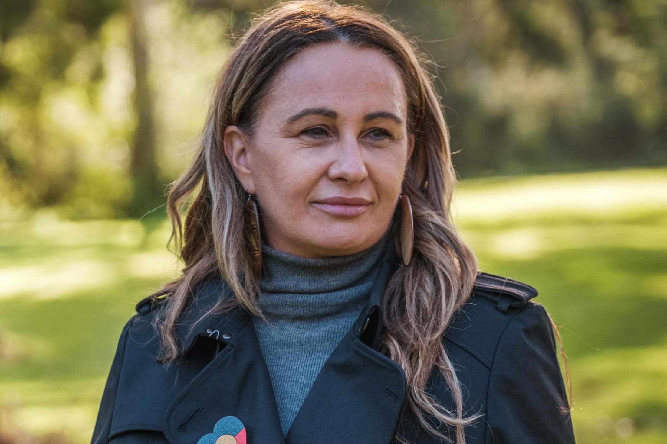 Headshot of Yoorrook Comissioner and Adjunct Professor Sue Anne Hunter oudoors.