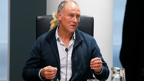 Anthony Craig from Goolum Goolum Aboriginal Co-Operative, wearing a blue jacket, gestures with raised hands at a Yoorrook public hearing.