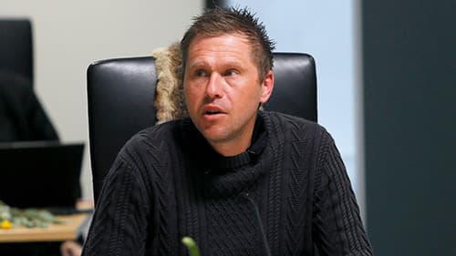 Dallas Widdicombe from Bendigo & District Aboriginal Co-Operative, seated and wearing a black turtleneck jumper at a Yoorrook public hearing.