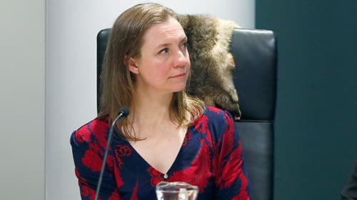 Katherine Whetton, Deputy Secretary, Mental Health and Wellbeing, Department of Health, sits at a black chair, indoors at a Yoorrook public hearing.